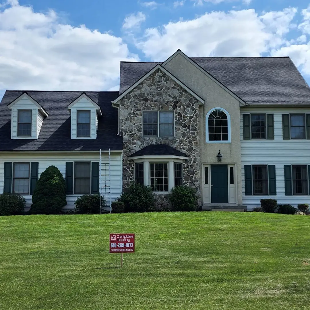 House with a "for sale" sign outside.