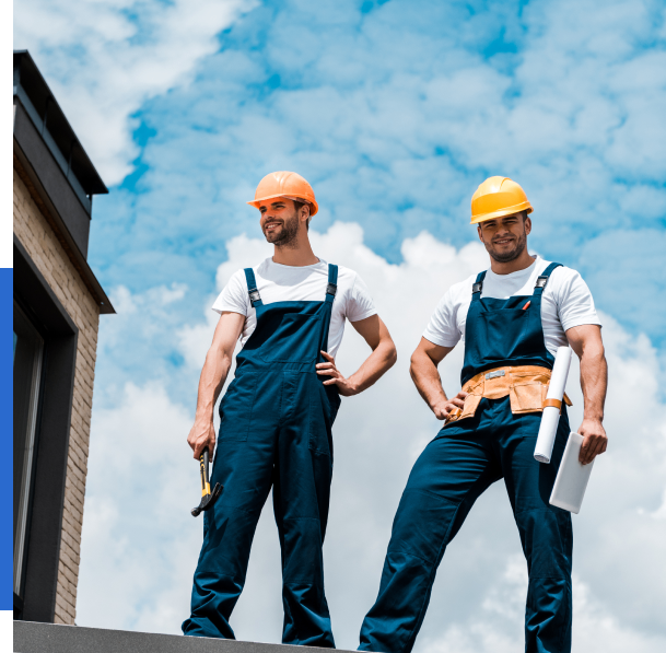 Group 71 Construction workers standing on a building rooftop.