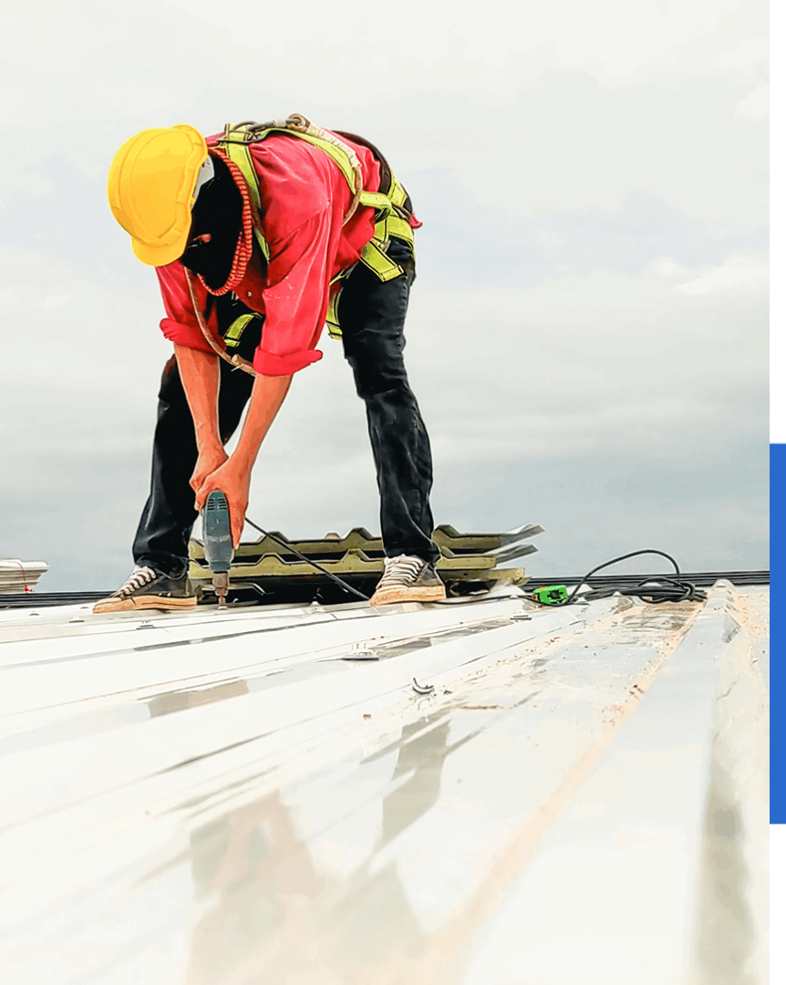Group 73 (2) Worker installing metal roof with drill.