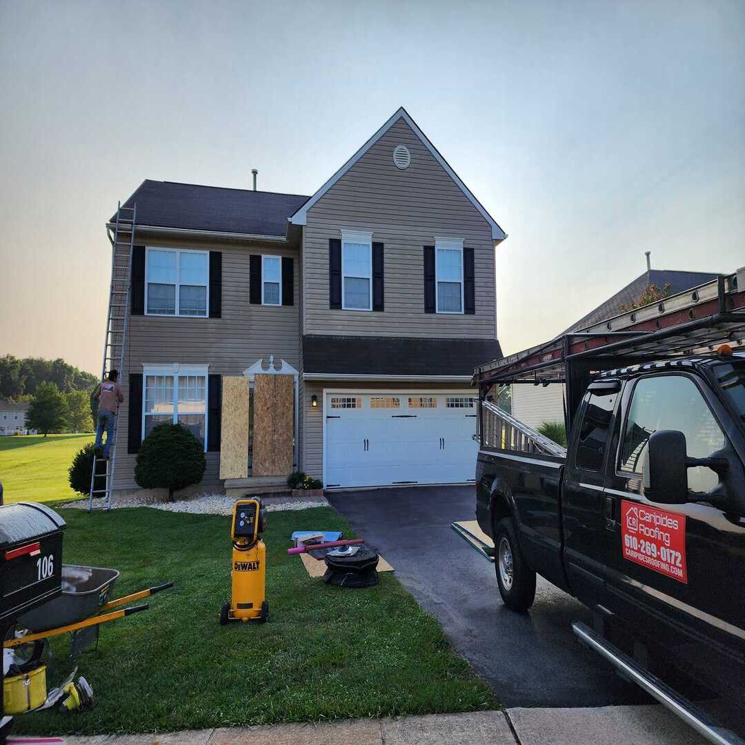 House exterior with repair equipment and truck.